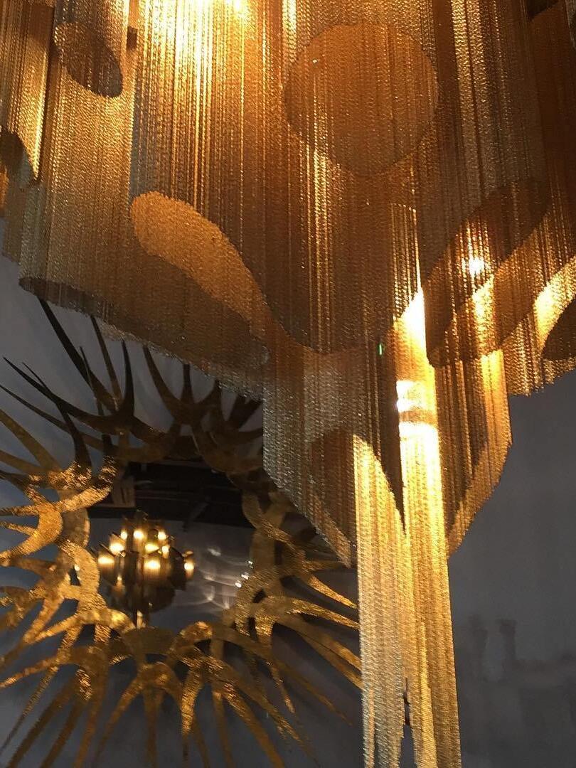 Close-up of fine hanging chains in warm light