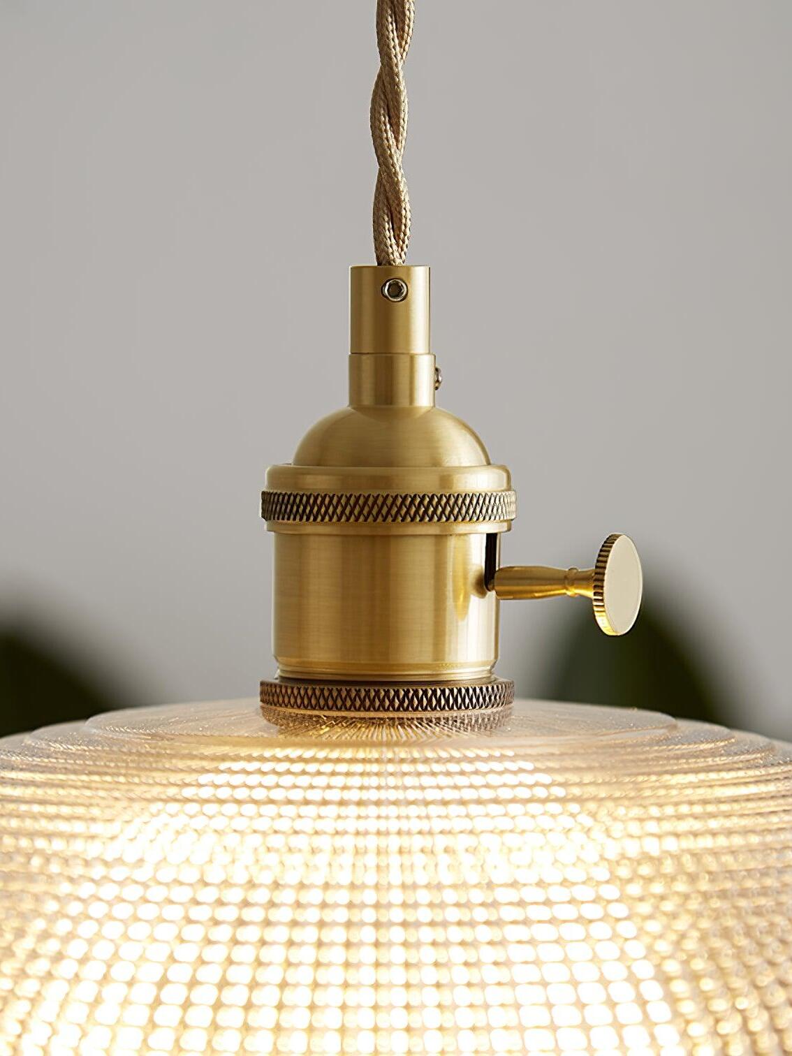 Close brass-colour socket housing above patterned glass