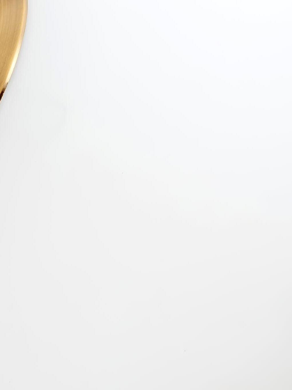 Narrow gold metal edge at top left of mostly white image