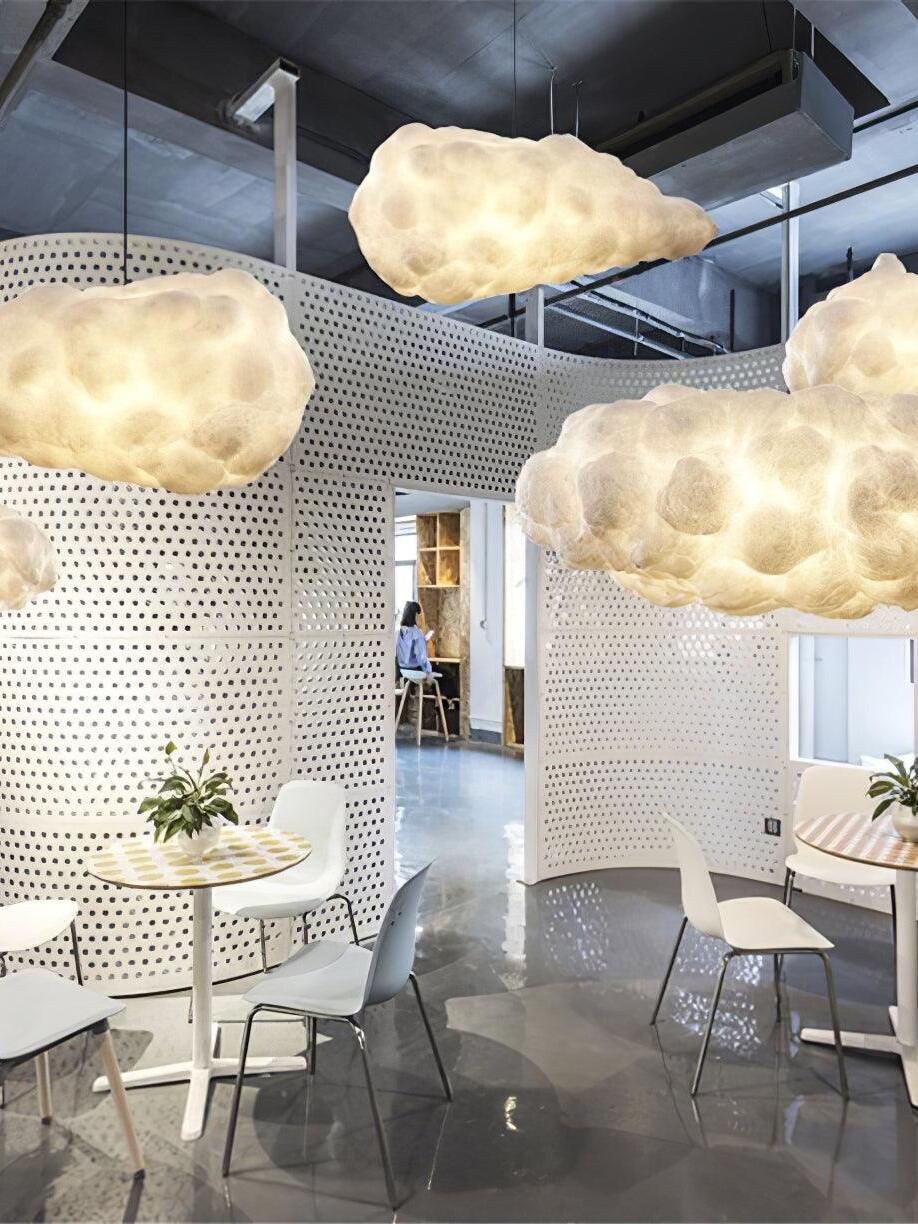 Cloud pendants above small tables in an indoor seating space