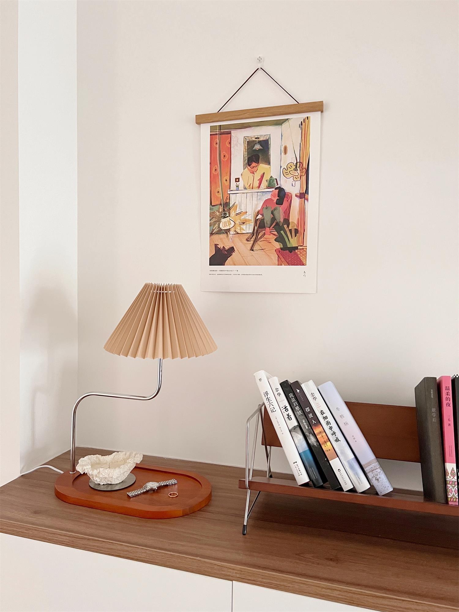 Brown pleated table lamp on long wooden tray