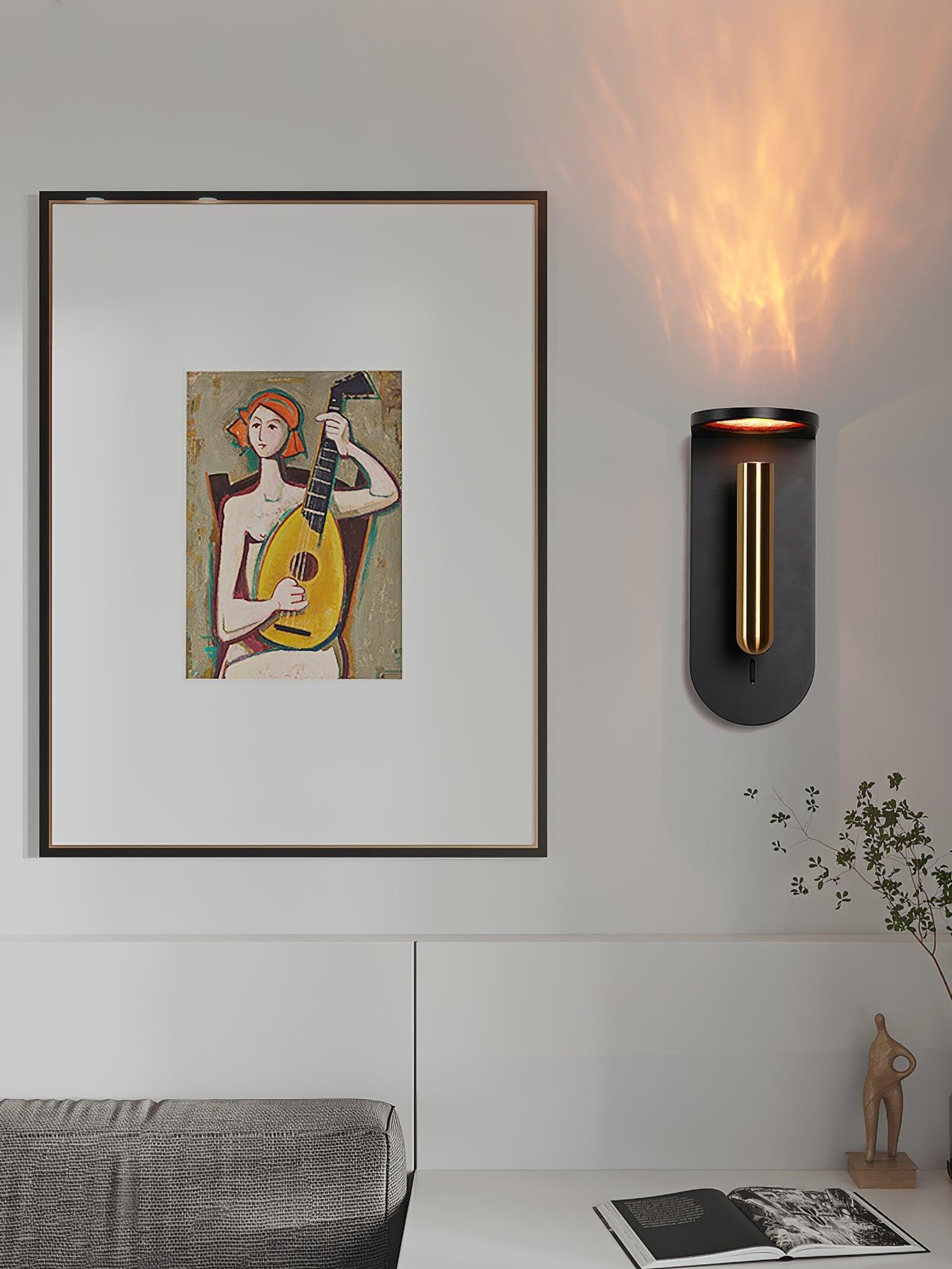 Black Nights wall light beside a large framed picture above a grey chair