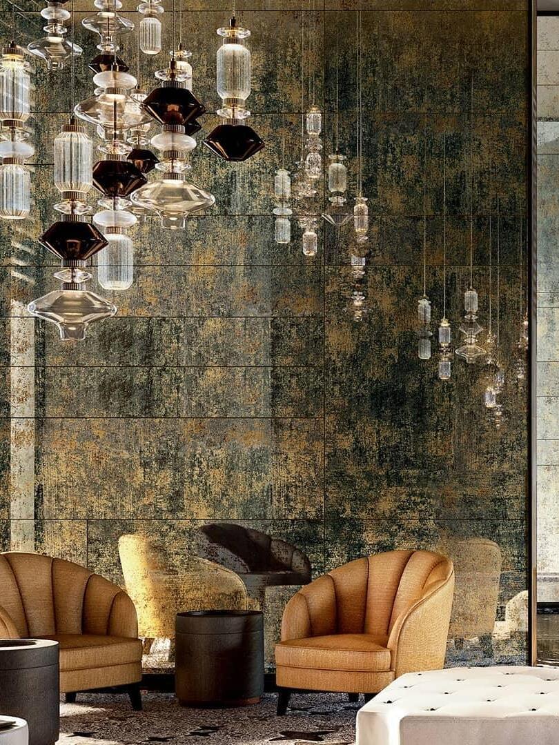 Mixed-height glass pendant installation by gold-grey wall