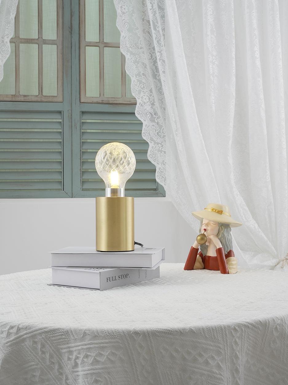 Glowing patterned globe lamp by curtain and green shutters