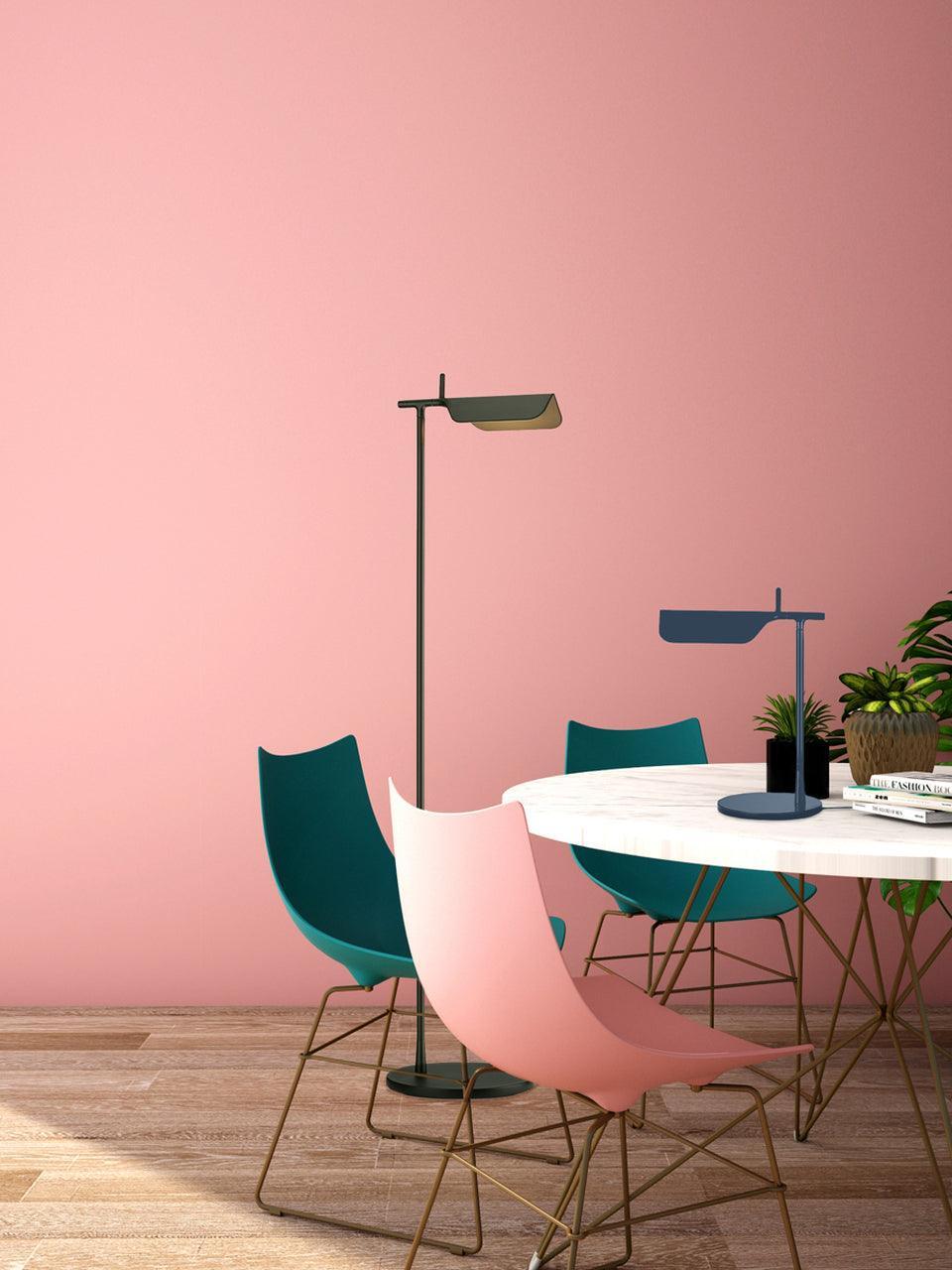 Green floor lamp and separate blue table lamp in a room