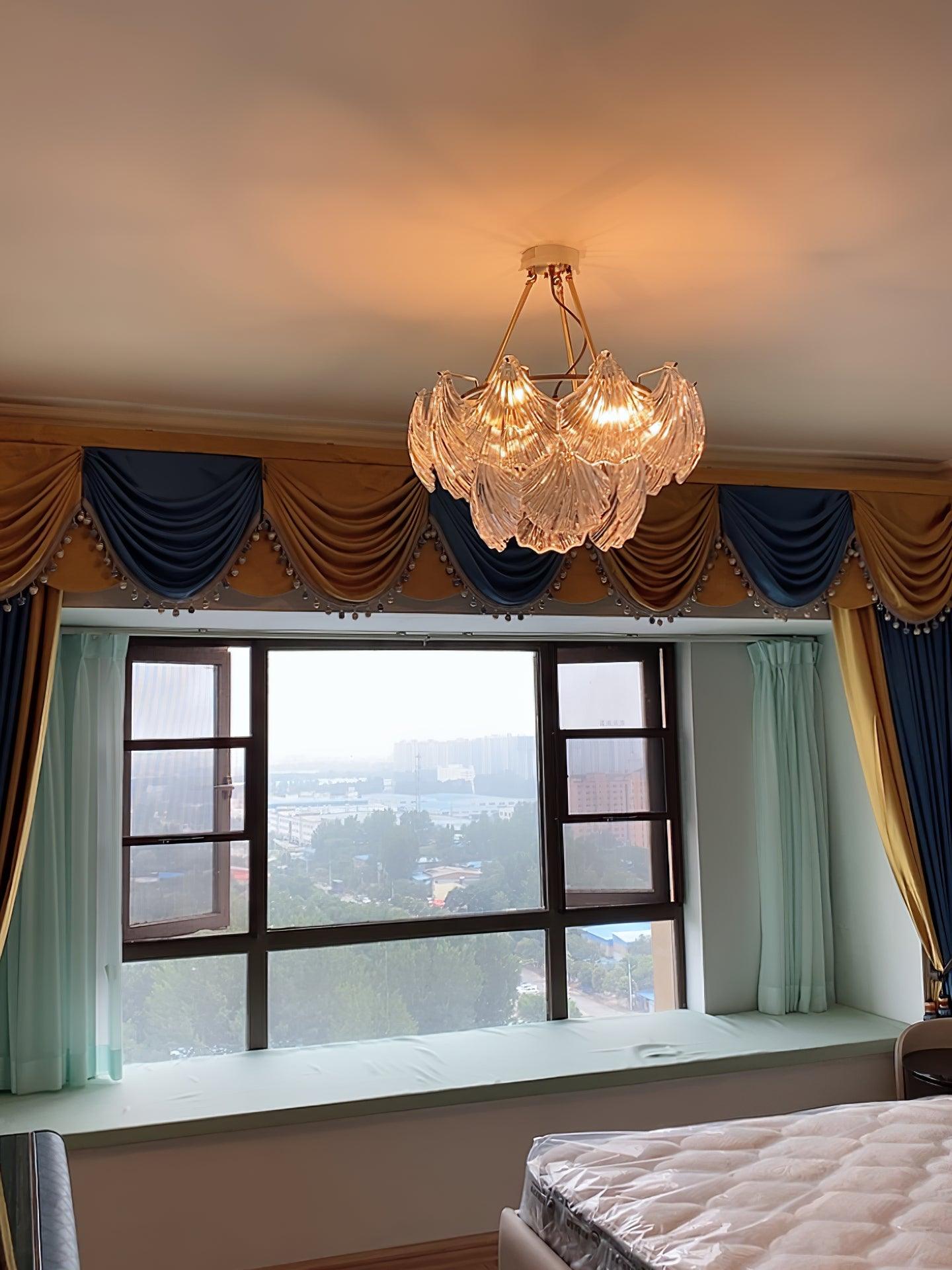 Warm-looking illuminated glass light in a bedroom near a window with a draped valance