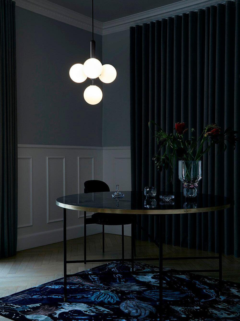 White globe cluster in a dark dining area