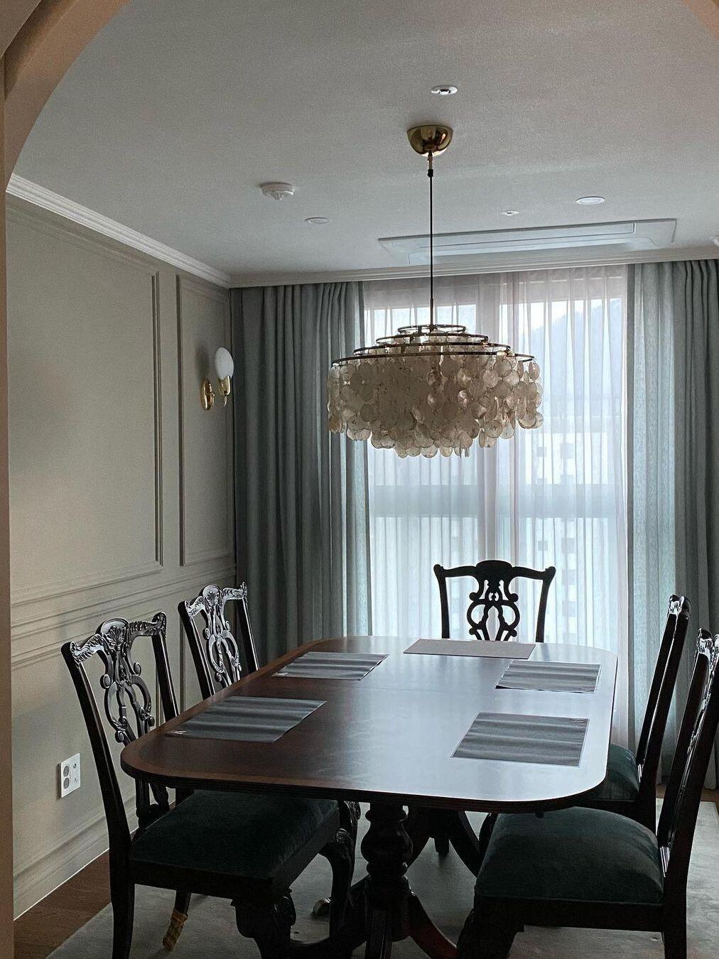 Shell fixture above a dark wooden table