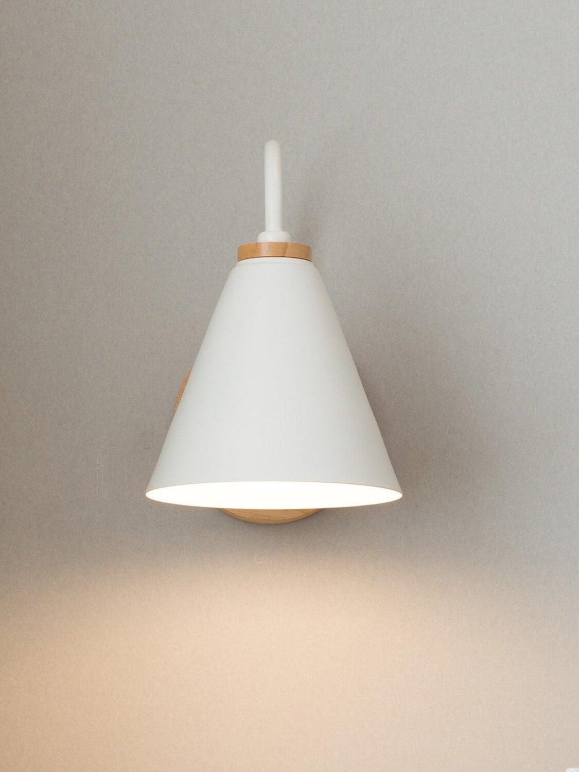 Front view of white cone shade and curved white arm