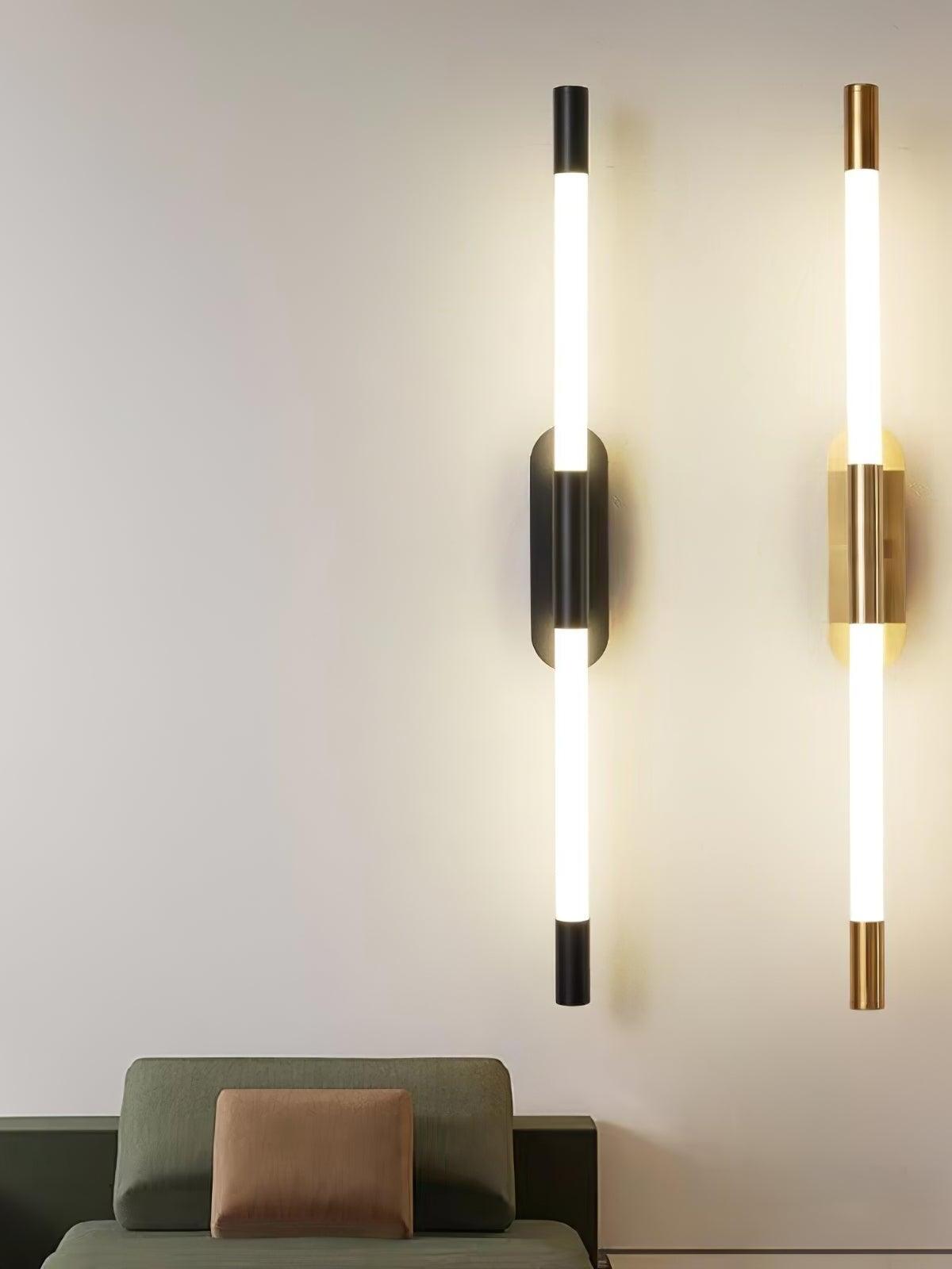 Black and gold Agnes wall lights mounted vertically above a chair