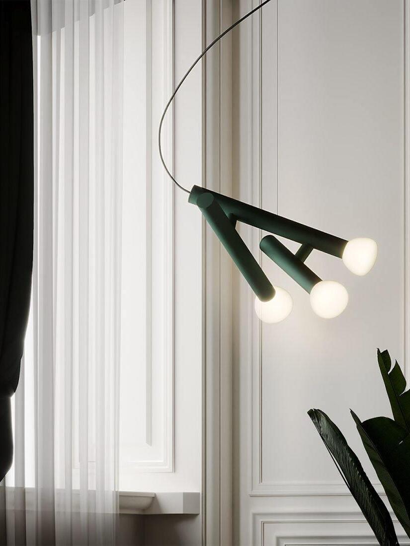 Green tube pendant beside tall curtains