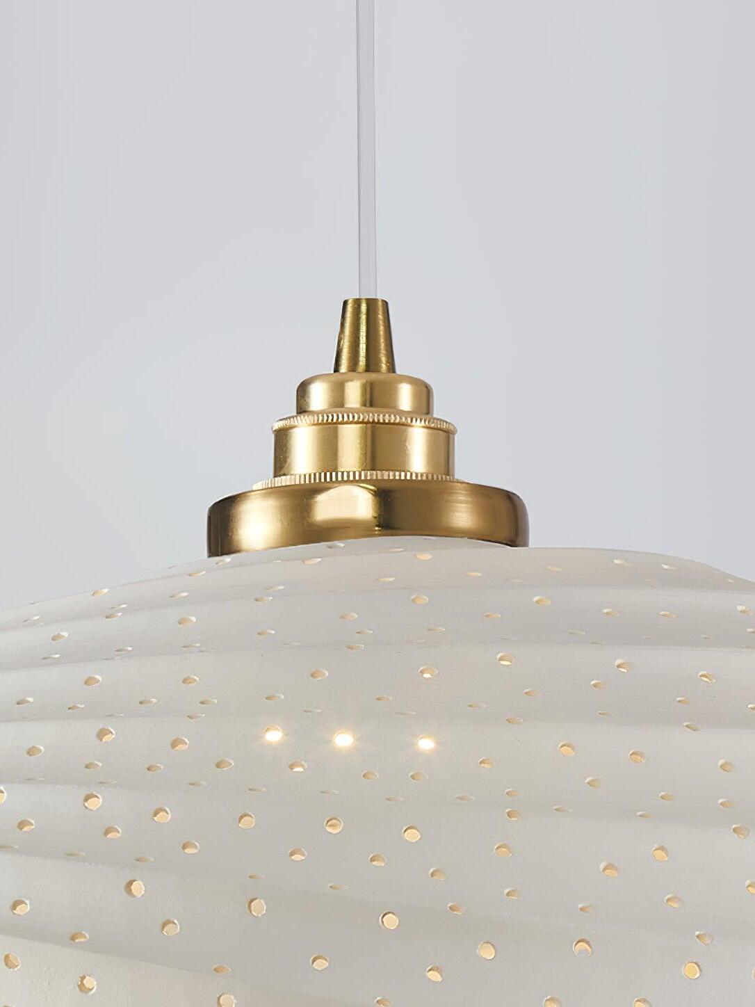 Close view of perforated White resin and gold-tone fitting