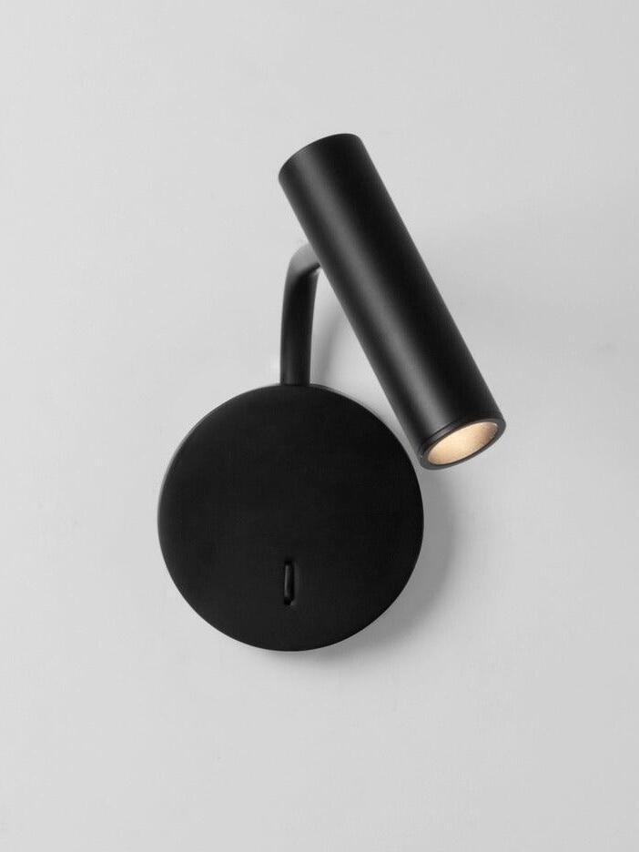 Black cylindrical reading head above a round wall plate