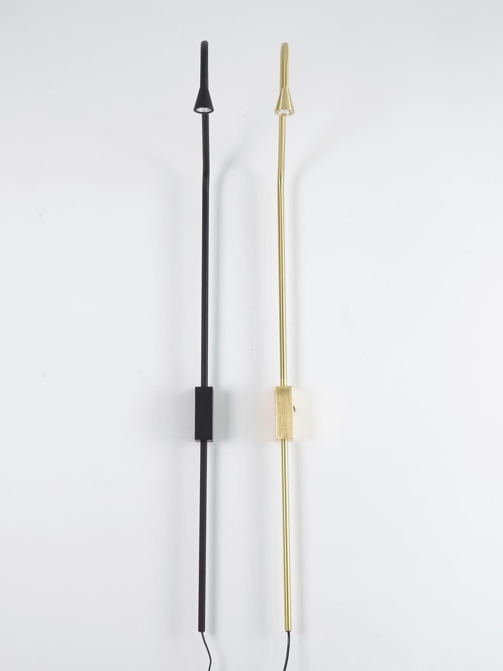 Two slim wall fixtures with small light heads