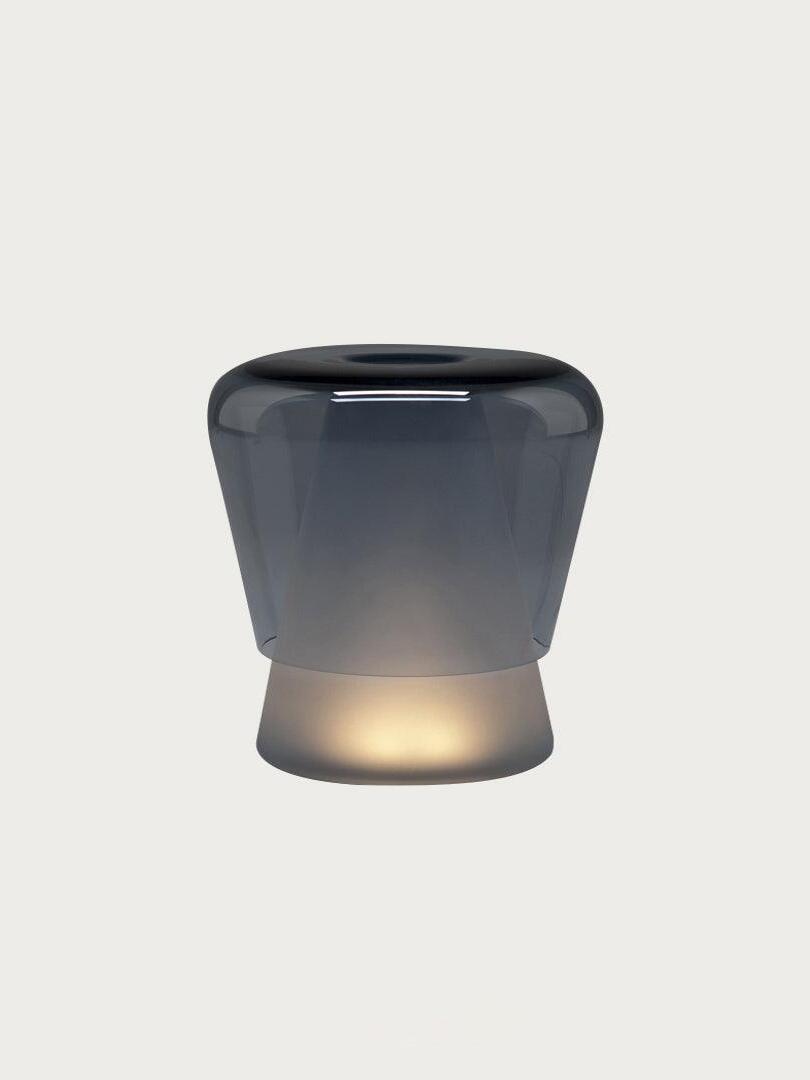 Blue Jumelle table lamp isolated on pale background
