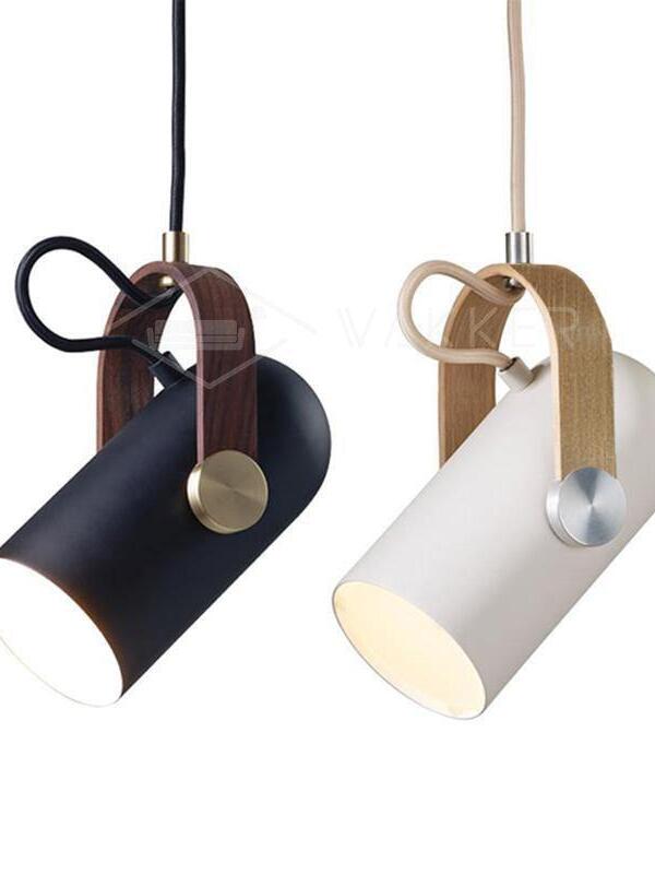 Black and white tilted pendant heads side by side, with contrasting wood brackets, metal fittings and cable colours