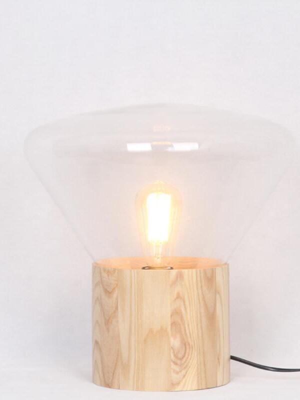 Clear flared shade with lit bulb over wood base, black cord visible at right