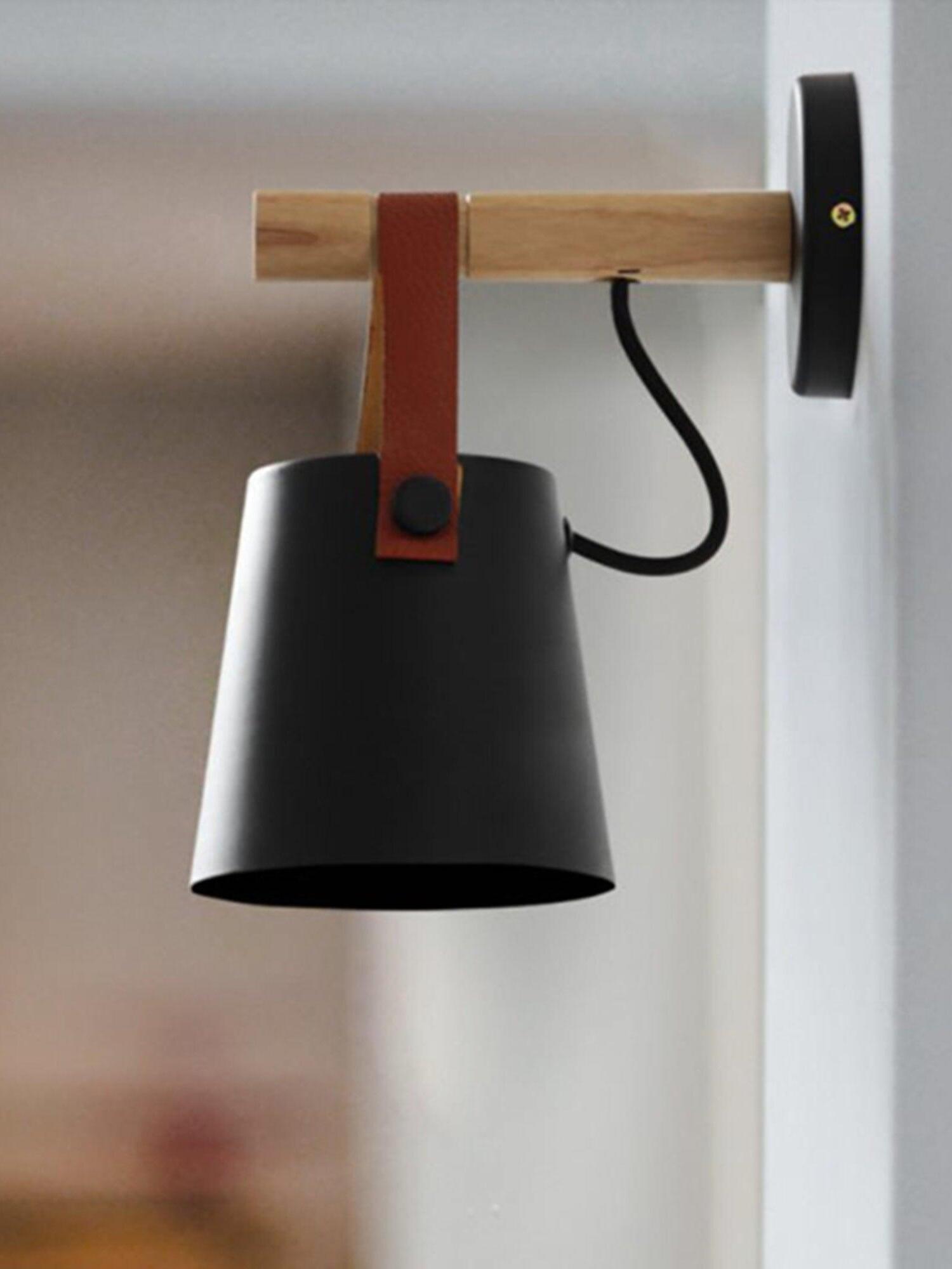 Brown strap and Black metal shade below a wood arm