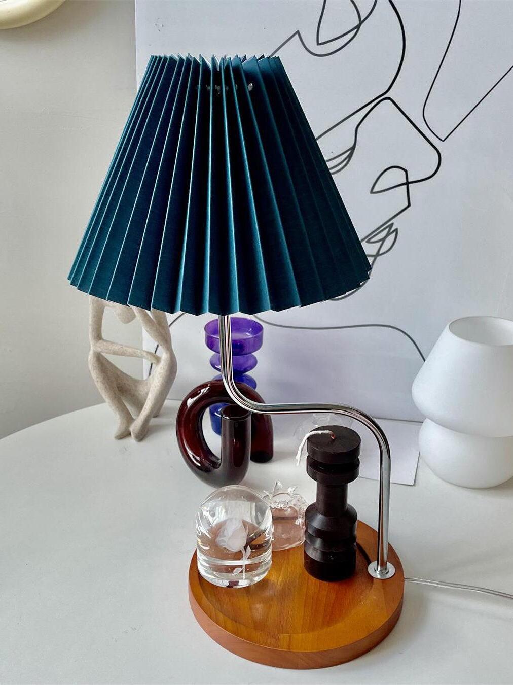Dark blue pleated shade above round wooden tray