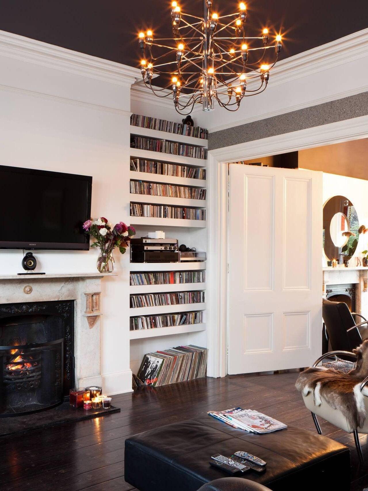 Exposed-bulb chandelier in a room with a bookcase