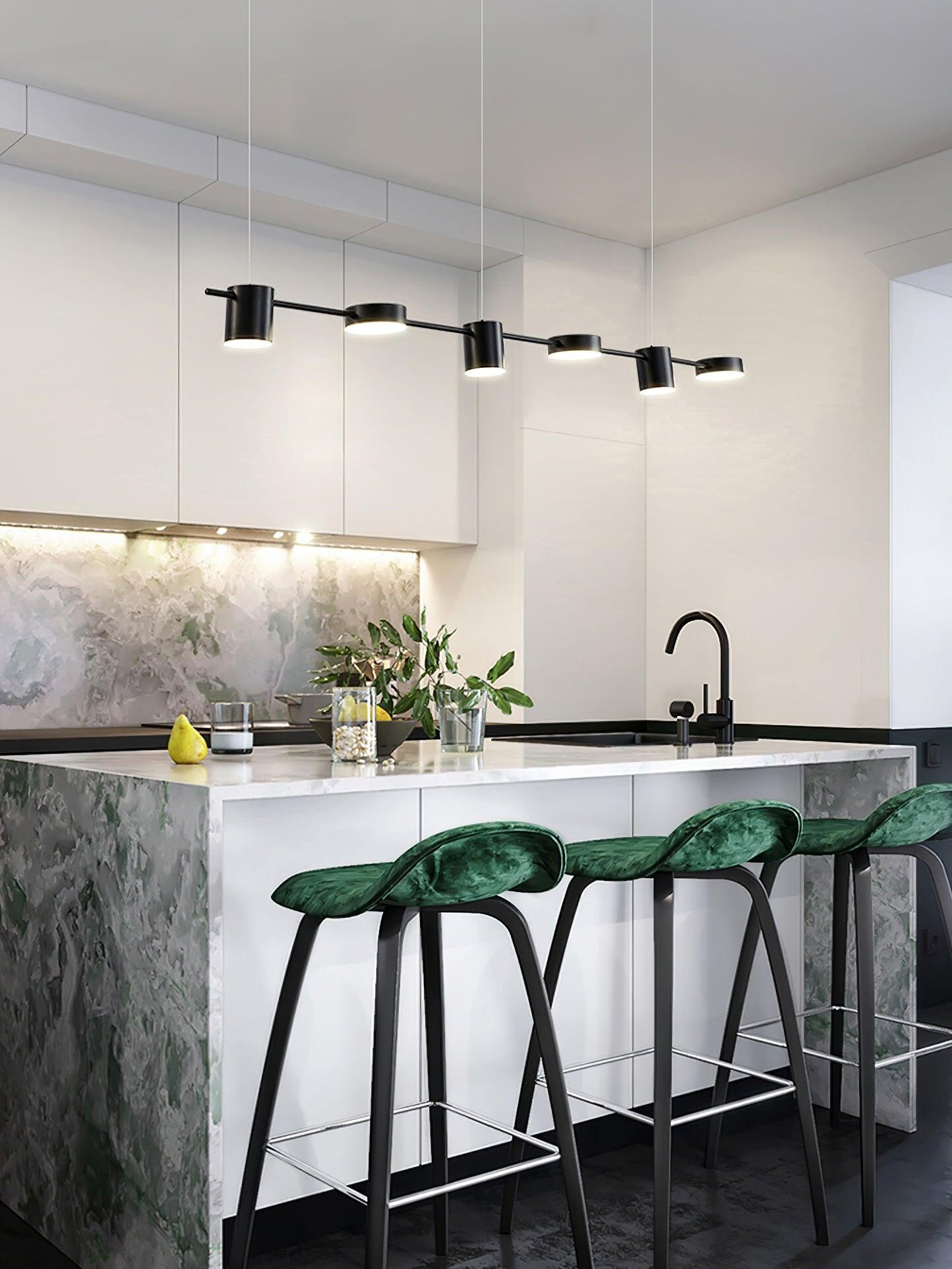 Black linear pendant above a green marble-patterned counter