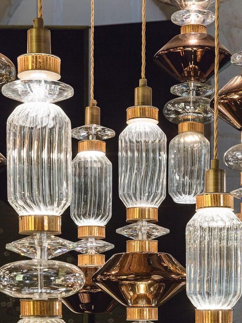 Ribbed clear glass cylinders with dark and gold-tone sections