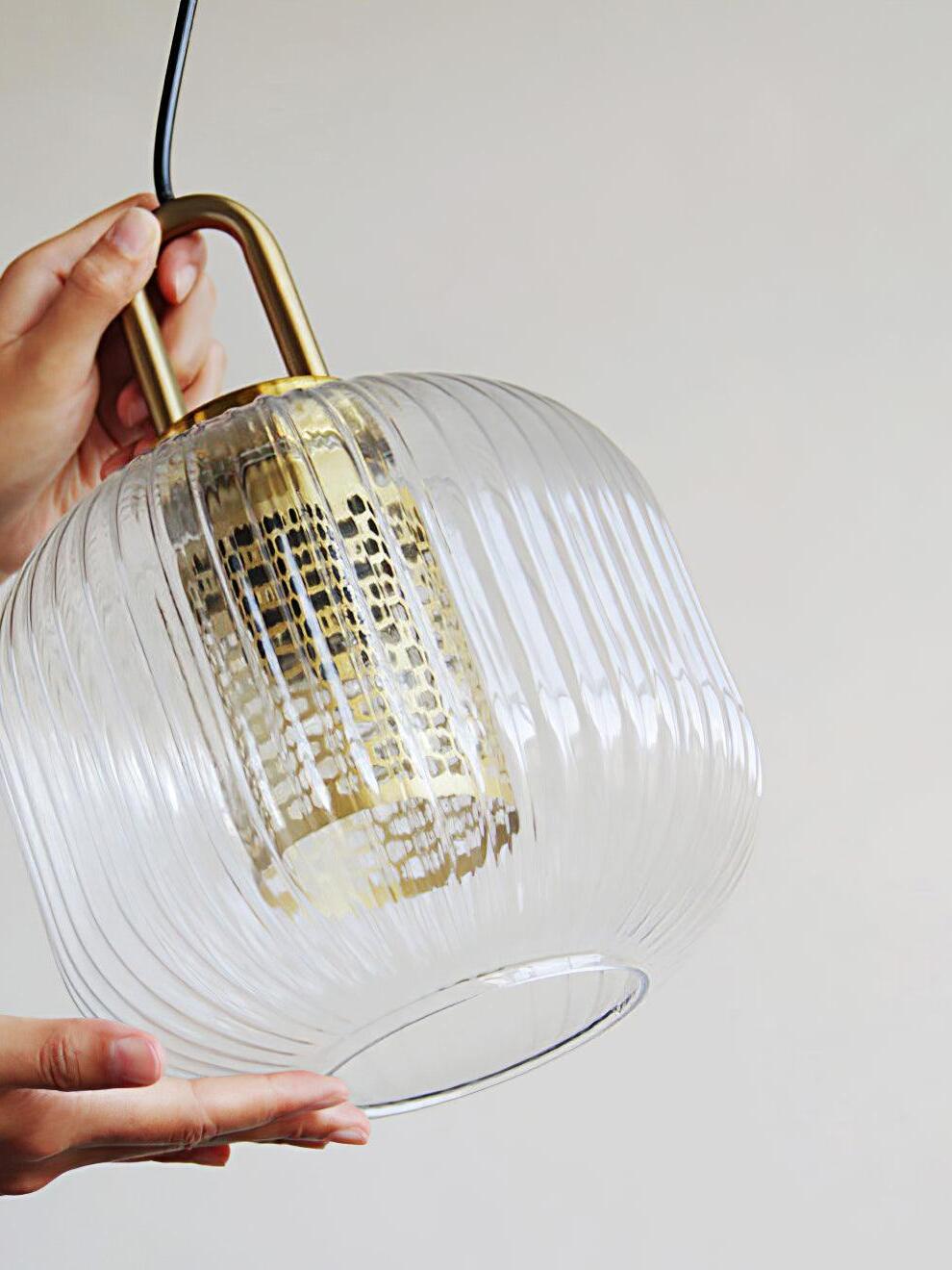 Hands holding ribbed shade with perforated inner cover
