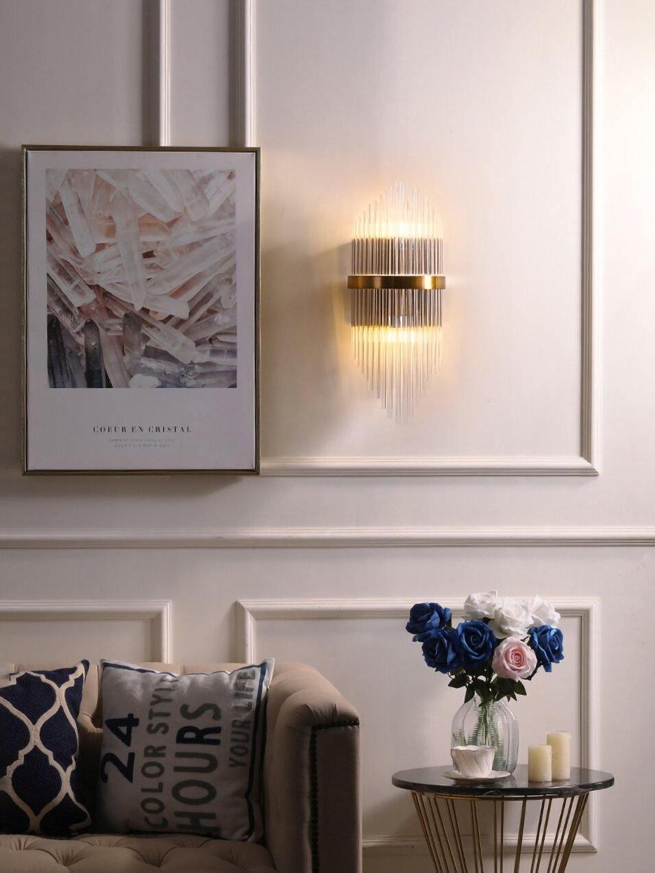 Upright crystal rod sconce above sofa and flowers