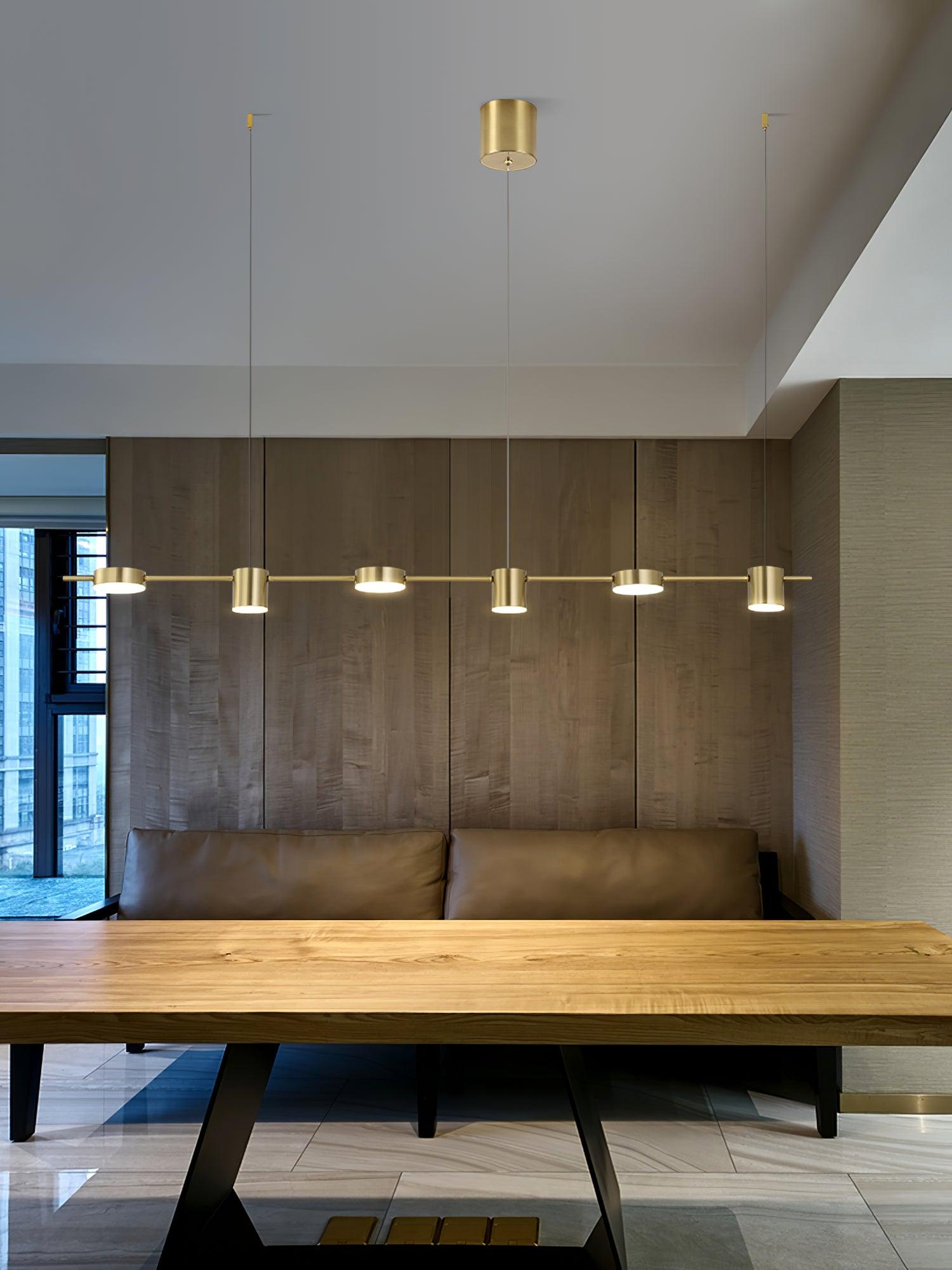 Gold linear light above a long wooden table
