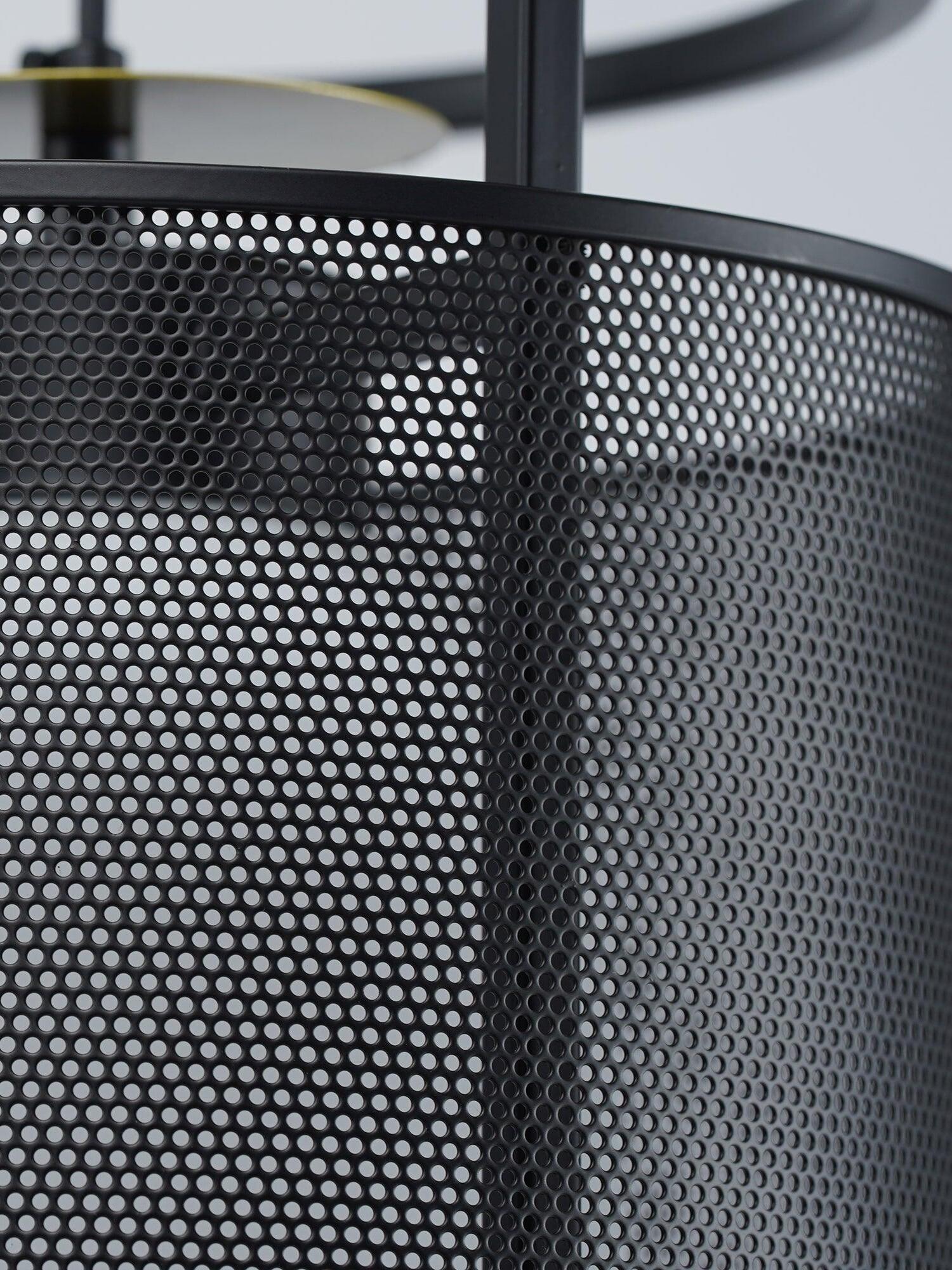 Angled close-up of black mesh and pale inner diffuser