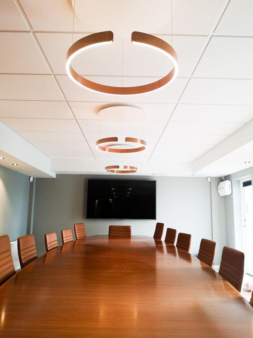 Circular lighting over a conference table