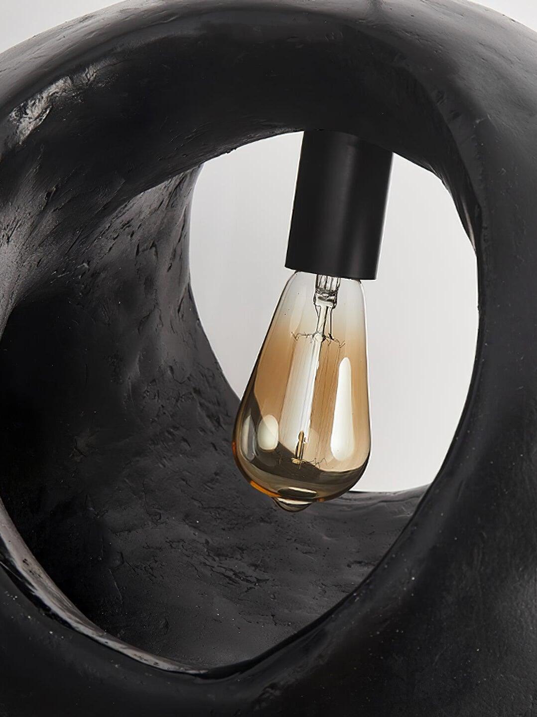 Filament-style bulb and holder seen through a shade opening