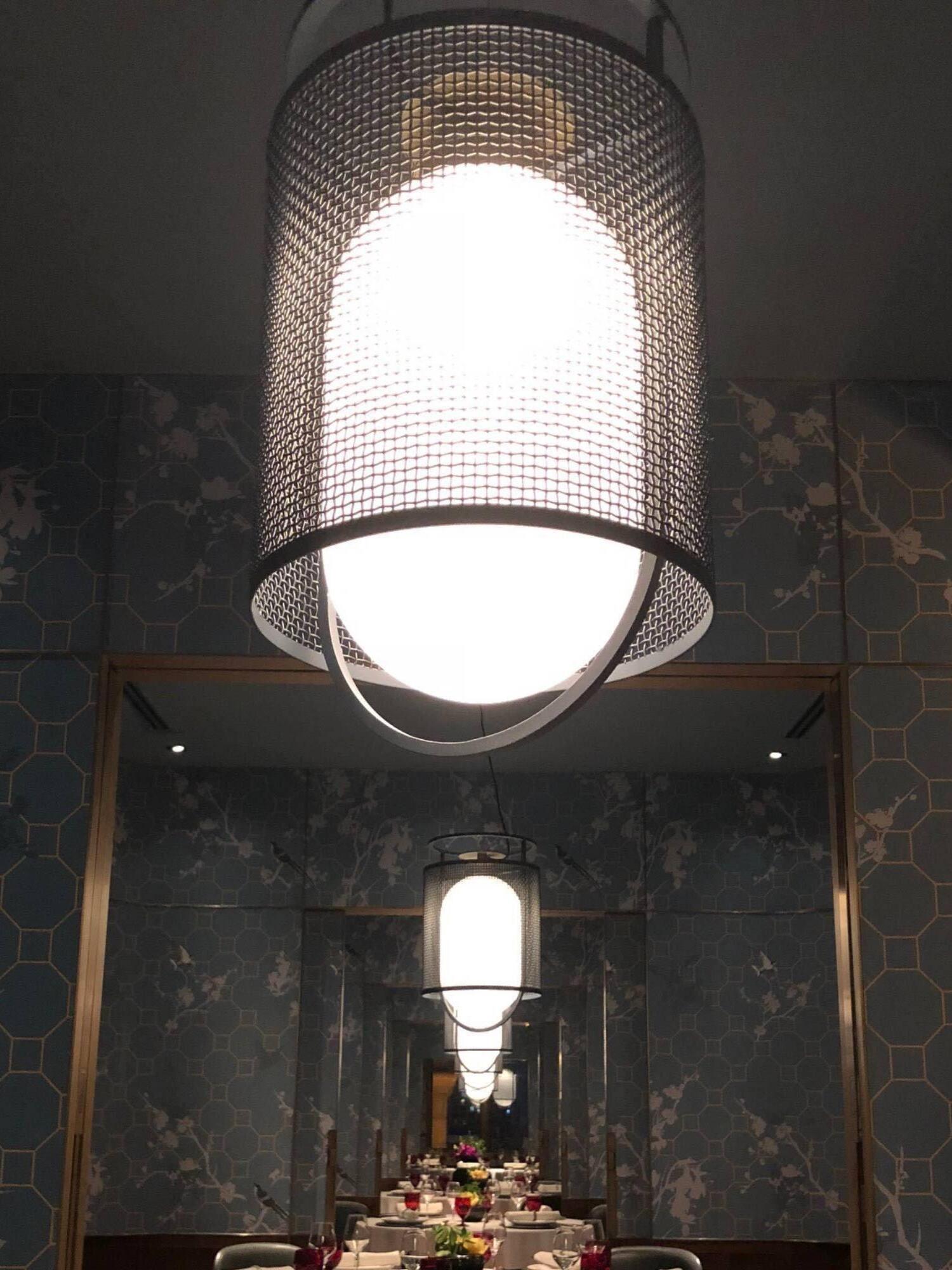 Close lit mesh lantern in a dark dining room
