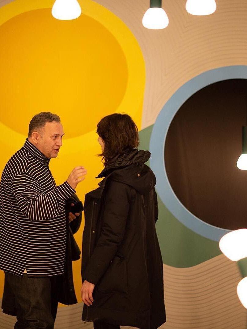 Pendant lights displayed in a colourful exhibition setting