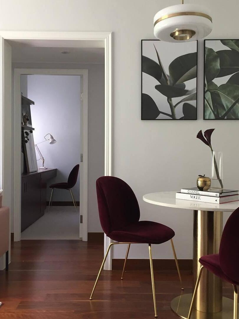 Round opal-glass pendant above a small dining table