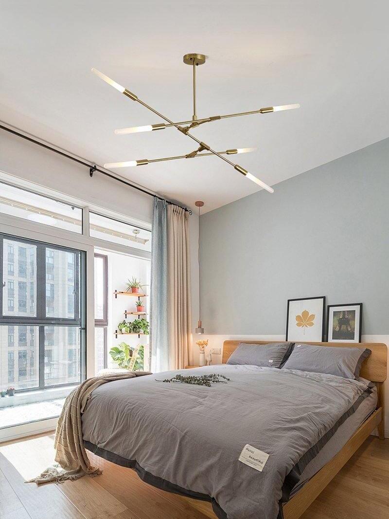 Horizontal Gold chandelier above a bed
