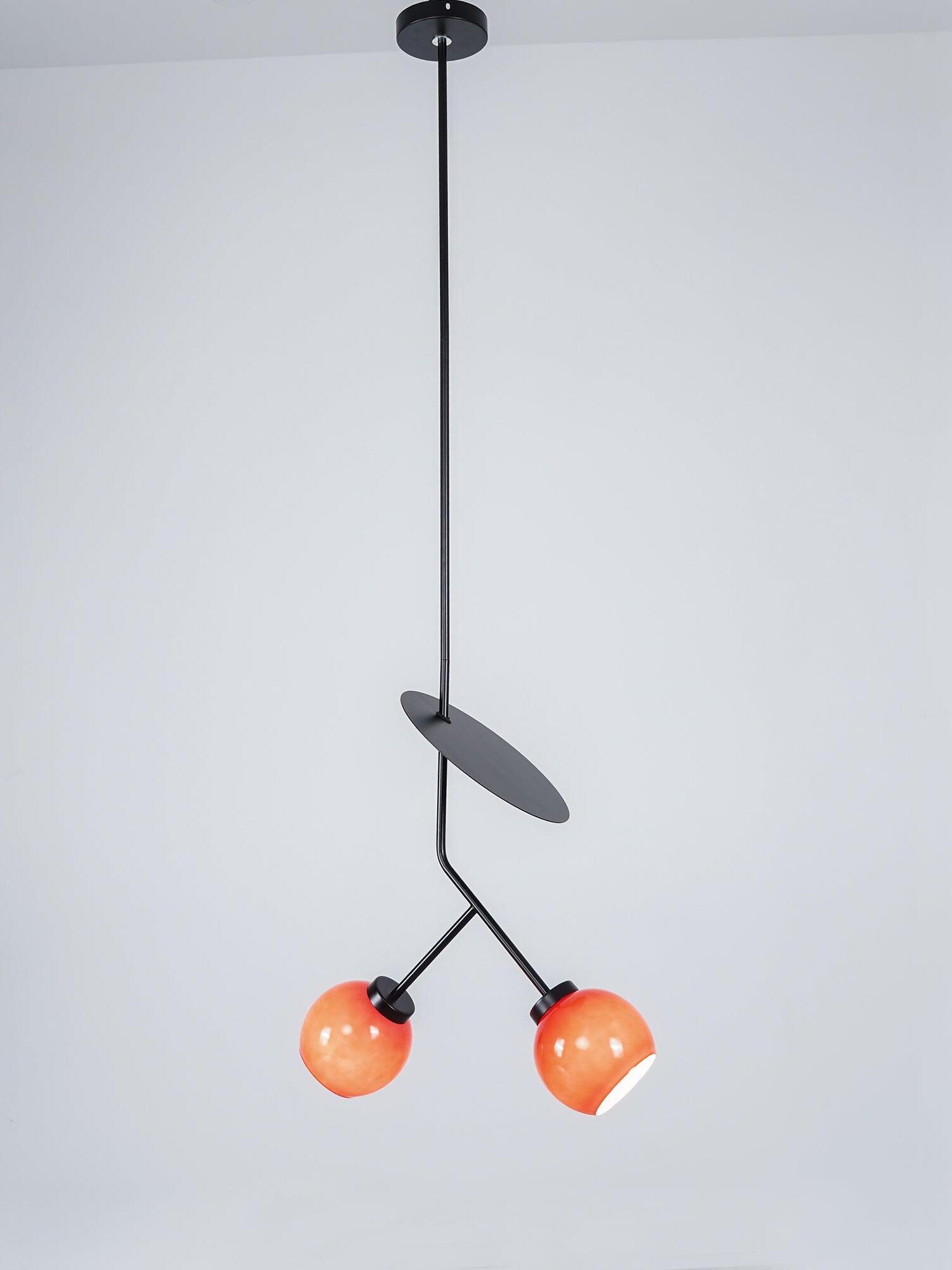 Illuminated round shades beneath a Black oval accent