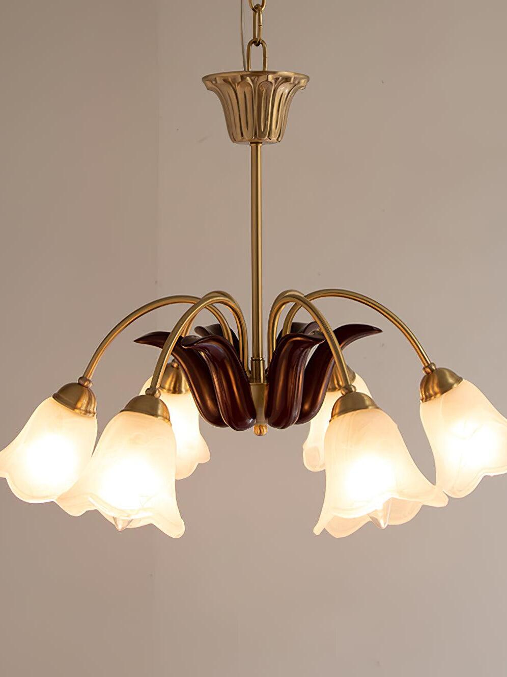 Lit floral chandelier with burgundy central leaf forms