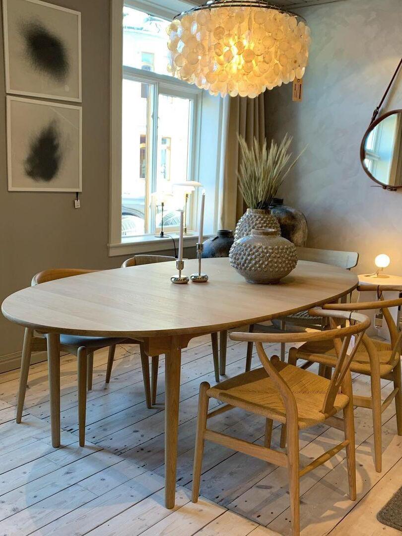 Warm-looking shell chandelier above a wooden table