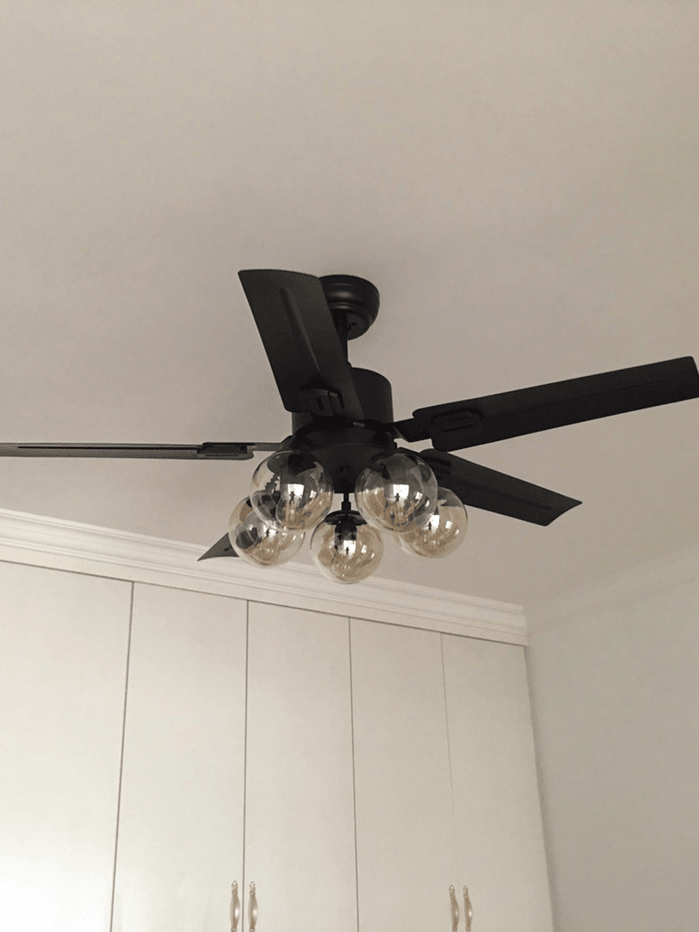 Angled room view of fan and glass light cluster