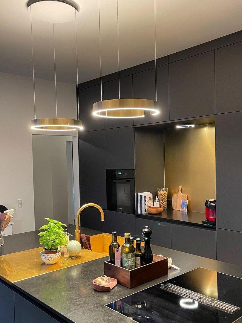 Two illuminated rings above a kitchen counter