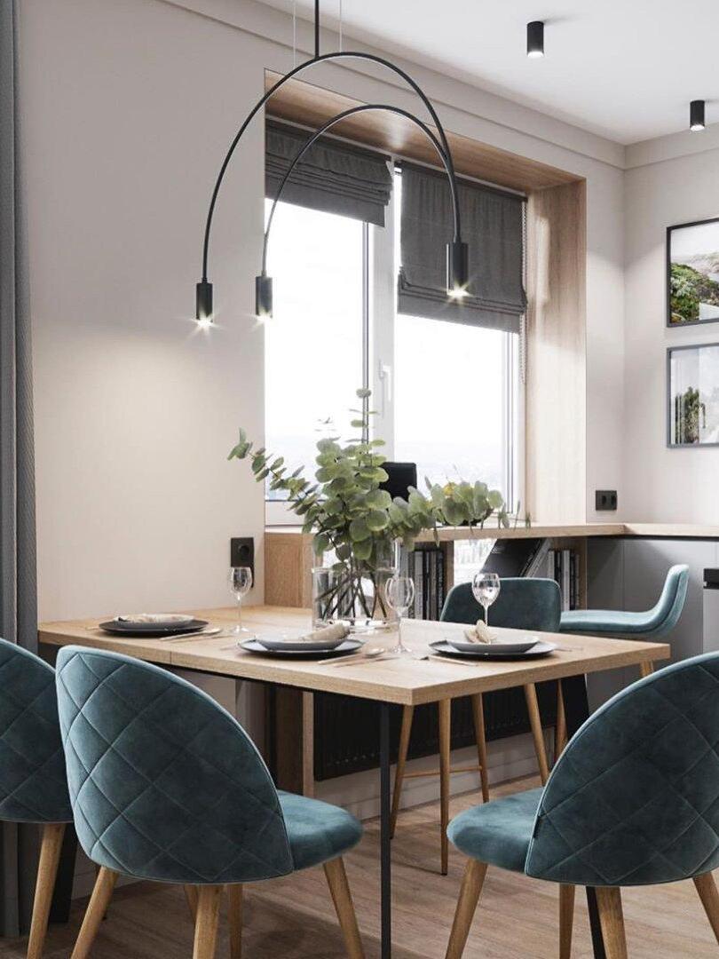 Arch pendant above a table beside a window