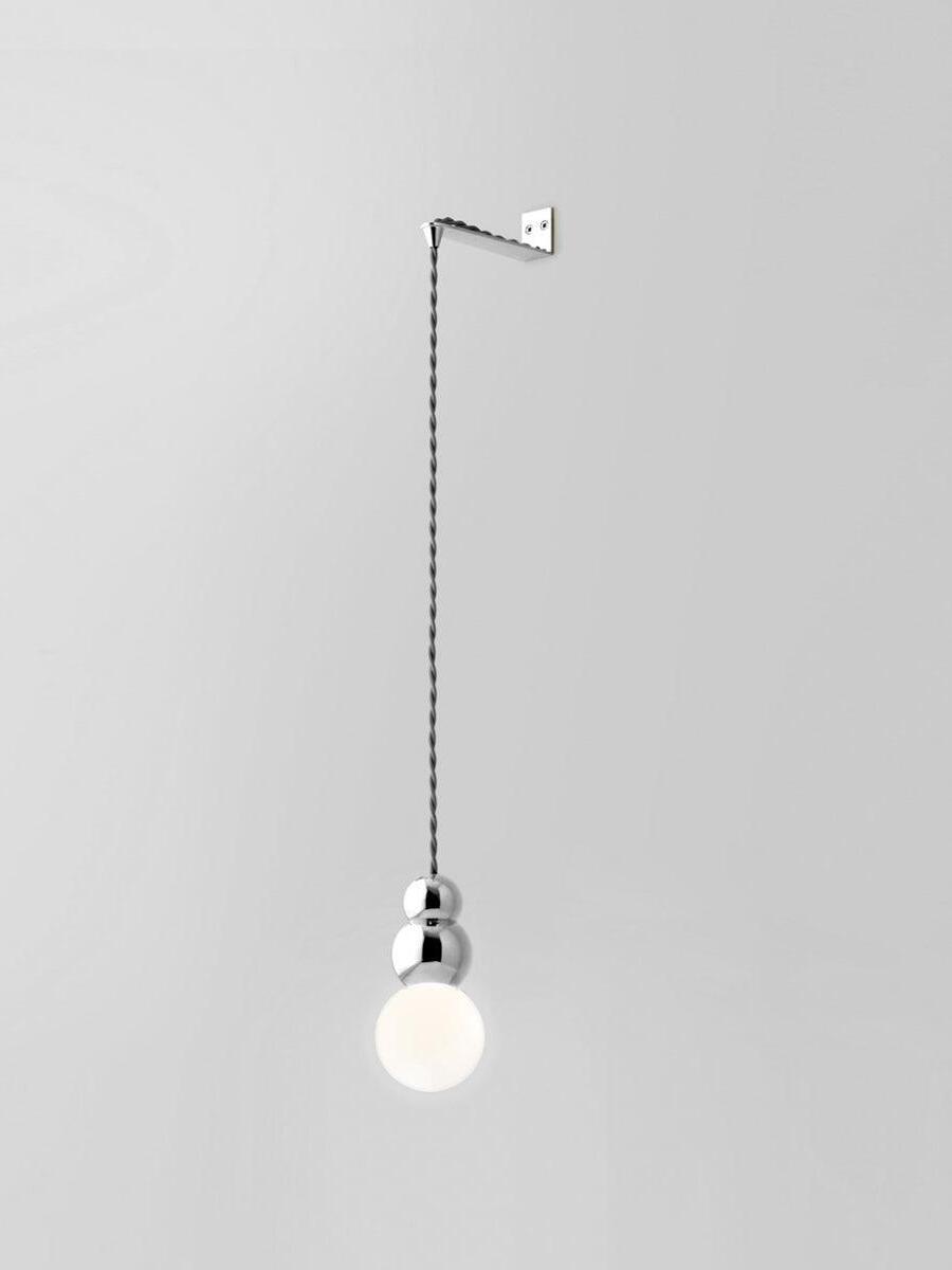 Chrome Flex wall light with larger glowing round bulb