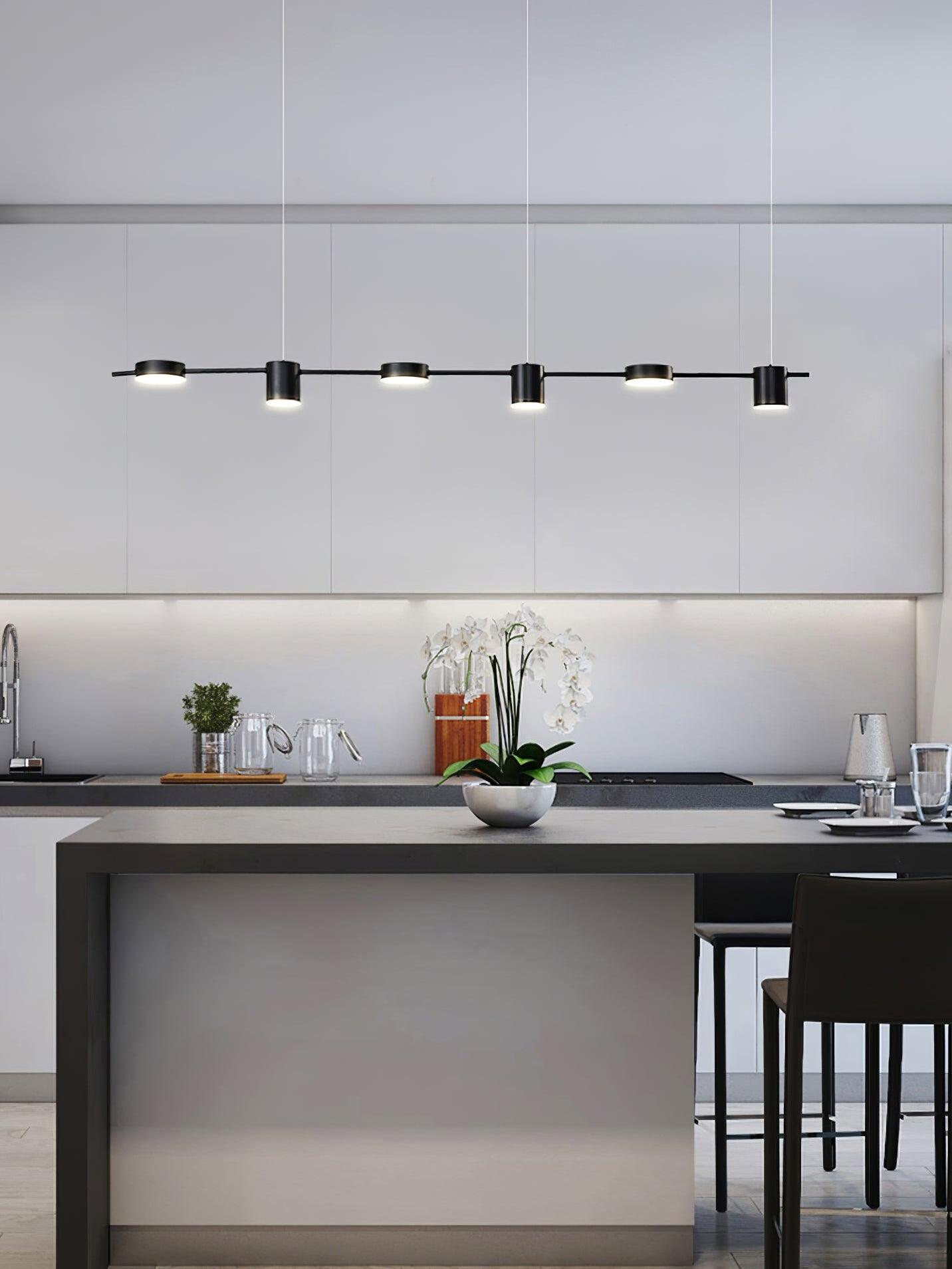 Black linear light across a kitchen island