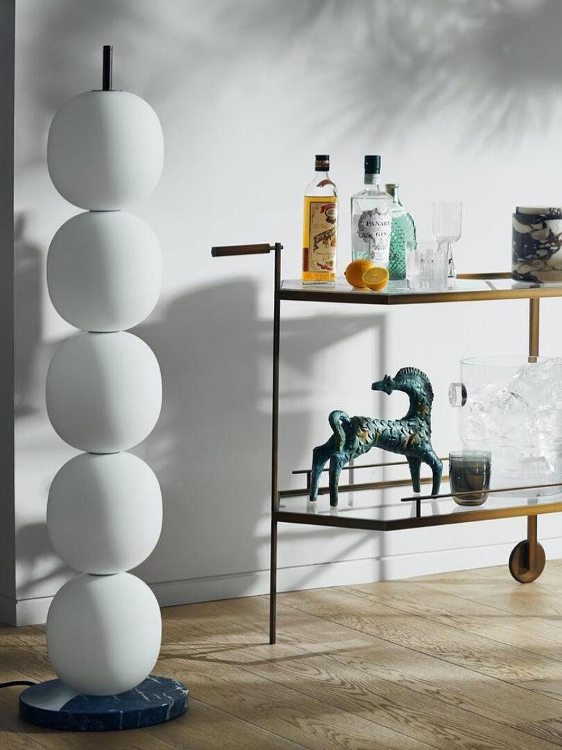 Unlit white globe lamp beside a drinks trolley