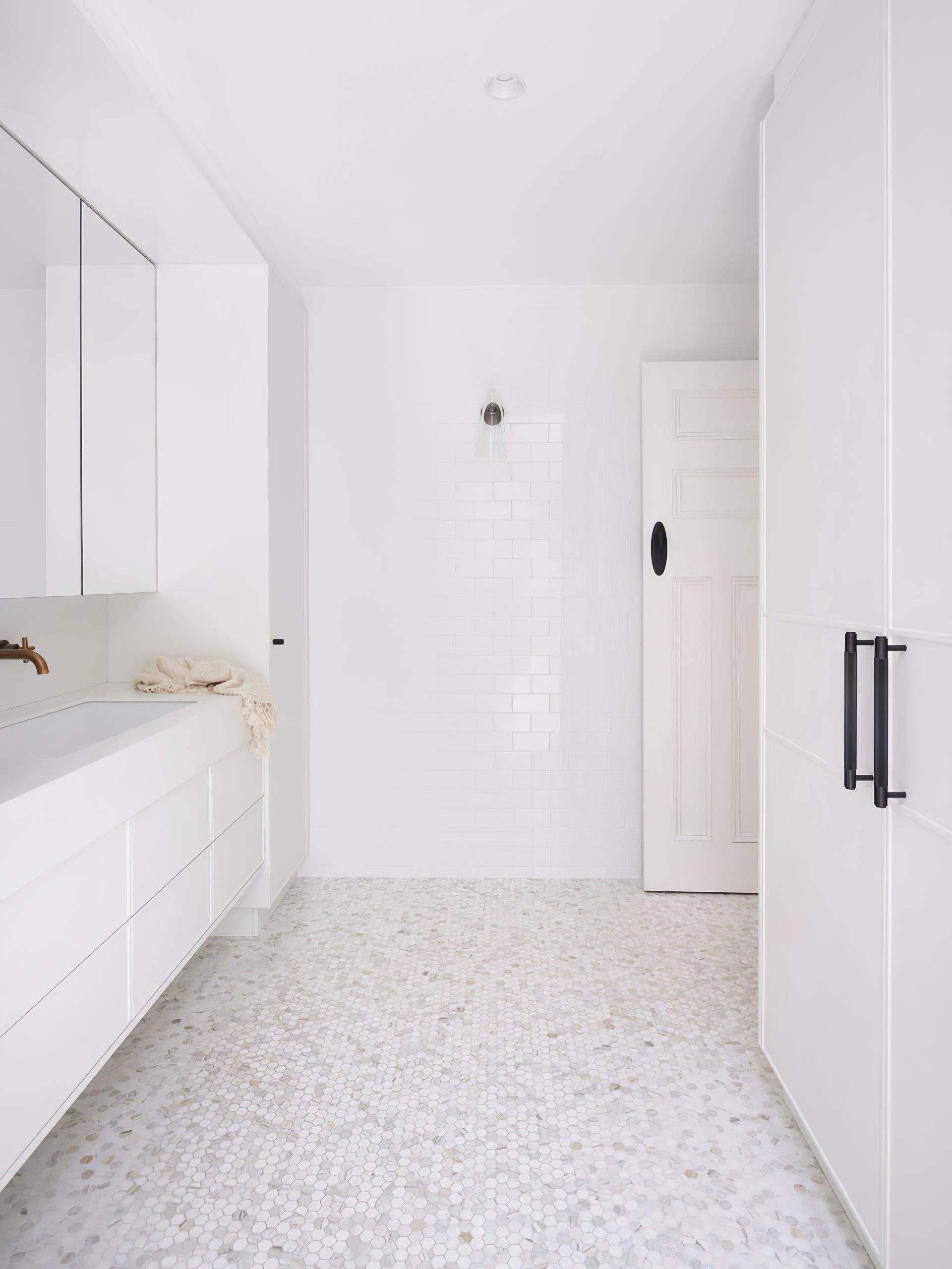 Small wall fixture in a bright bathroom scene