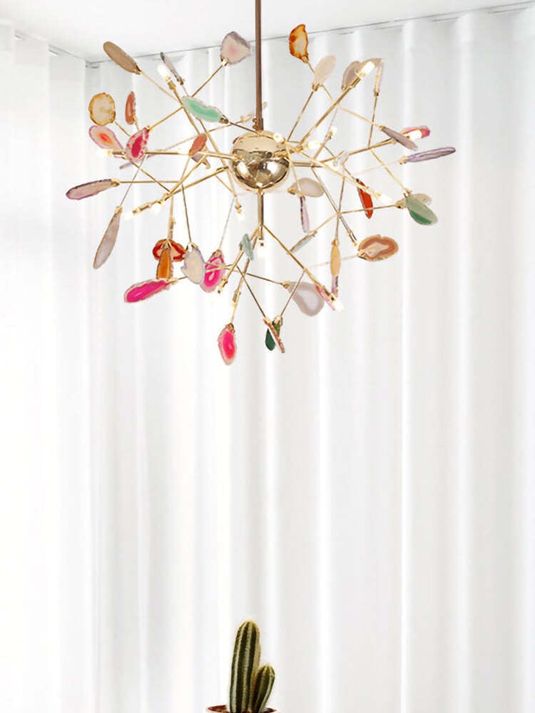Radial chandelier with stone slices beside a curtain