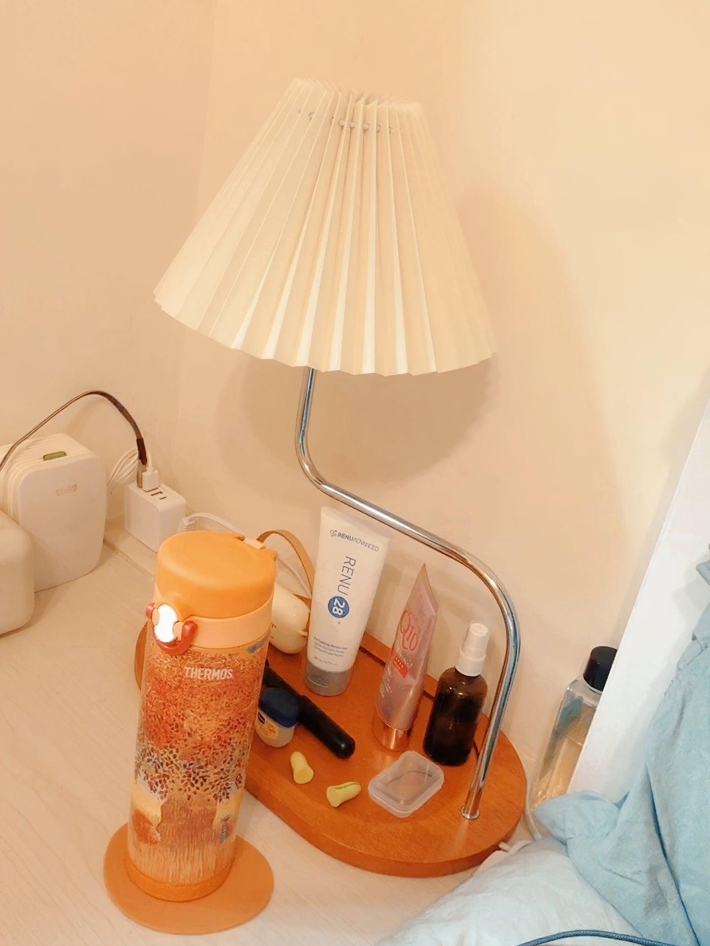 Orange-toned tray lamp photographed beside washbasin