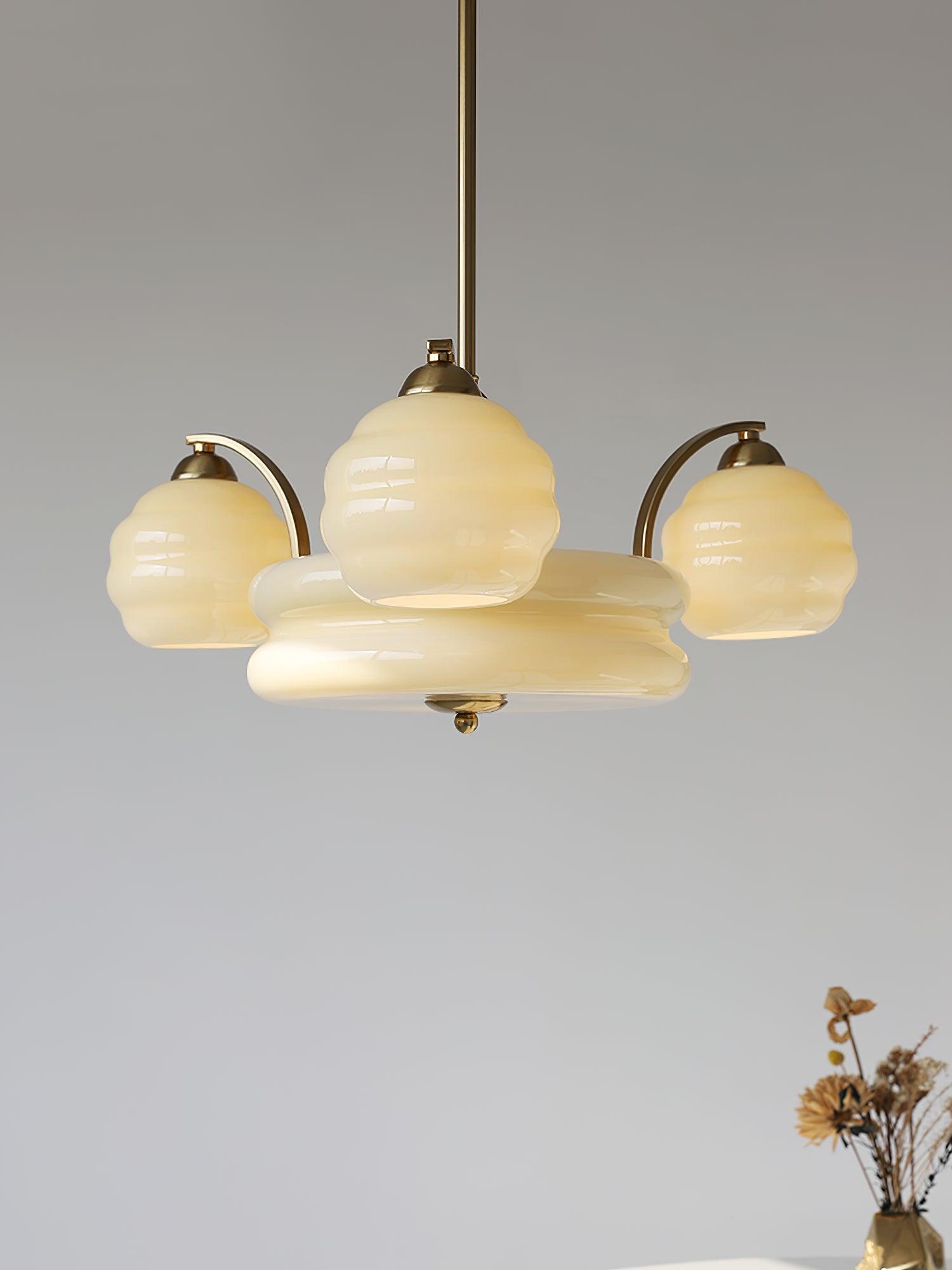 Beige glass chandelier against a grey wall