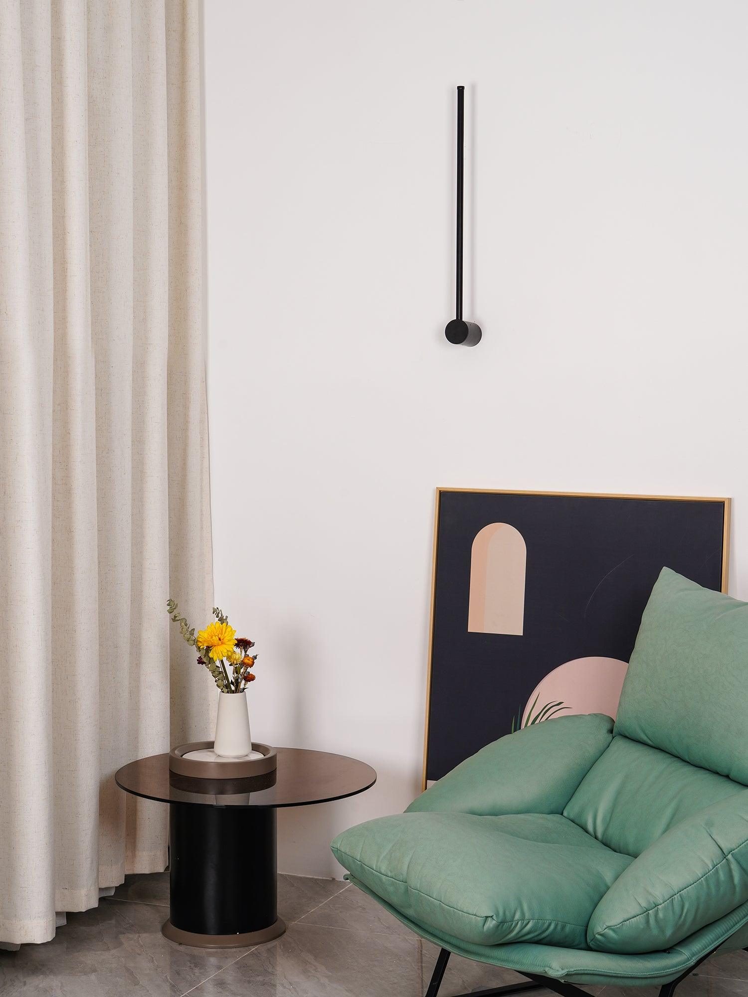Unlit short black rod above a small side table